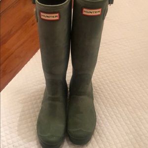 Hunter green tall rain boots.